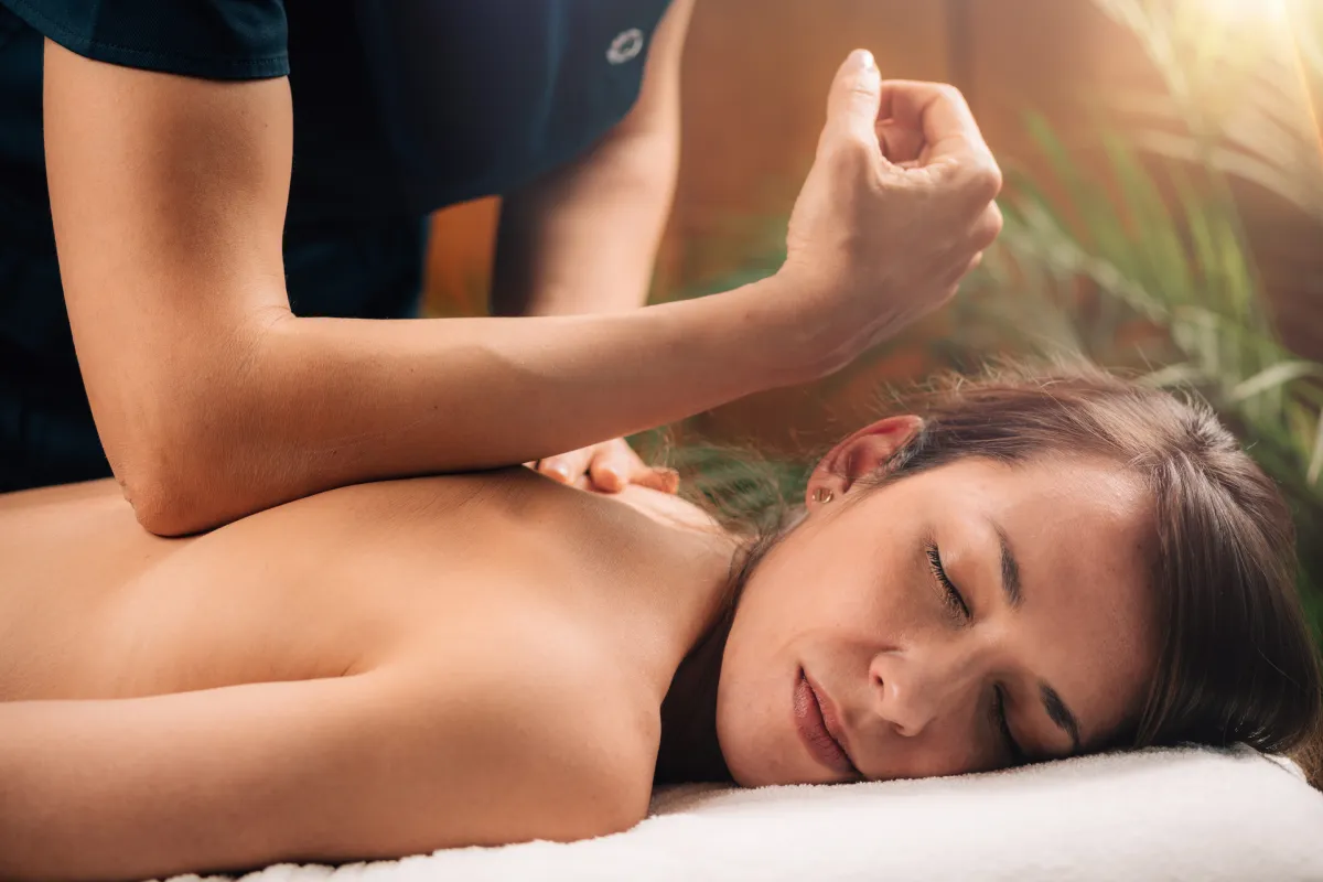 Woman receiving massage treatment for pain at EmpowerMed Longevity & Wellness
